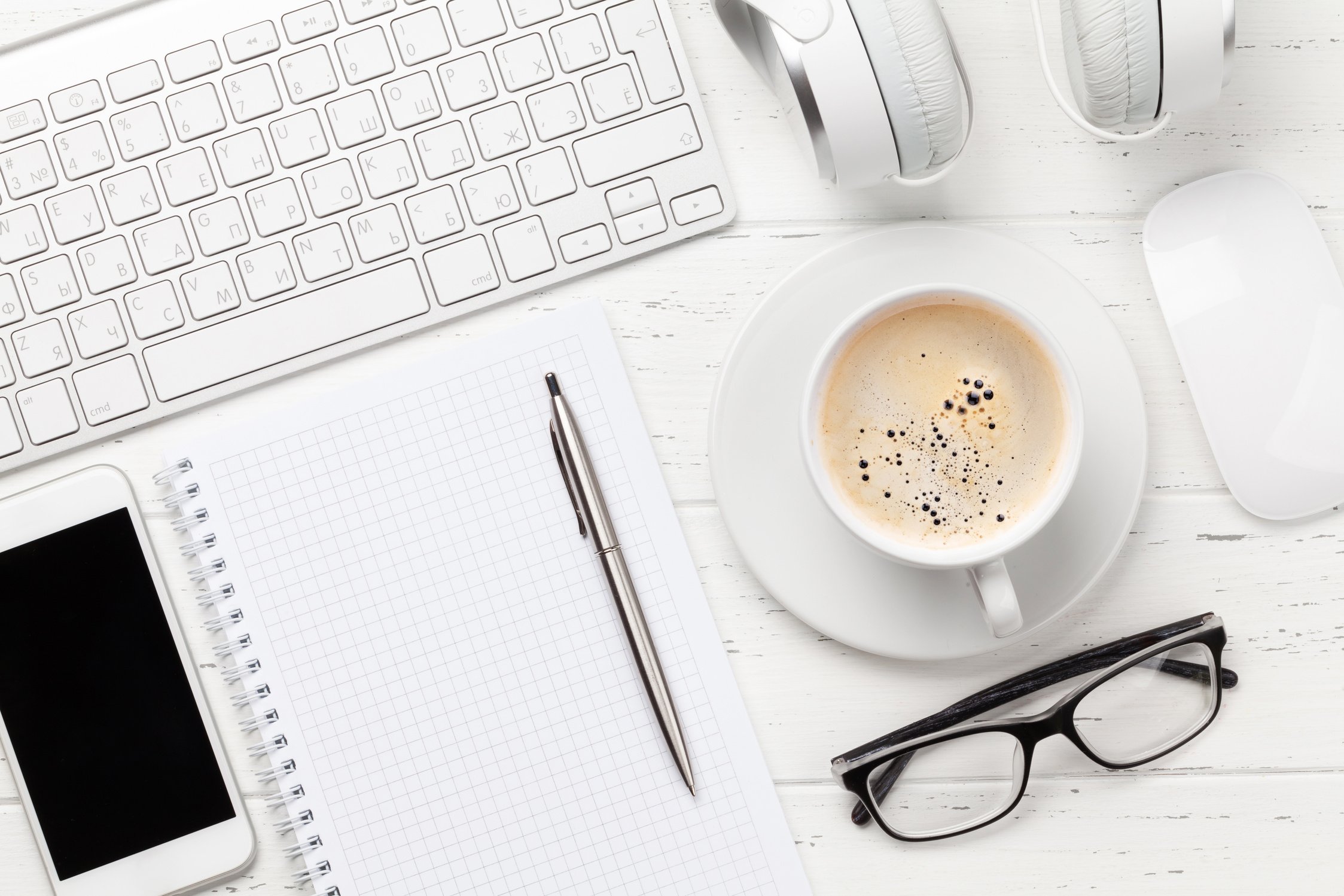 Workplace with computer, smartphone and coffee